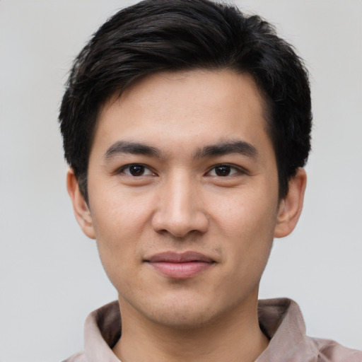 Joyful asian young-adult male with short  black hair and brown eyes