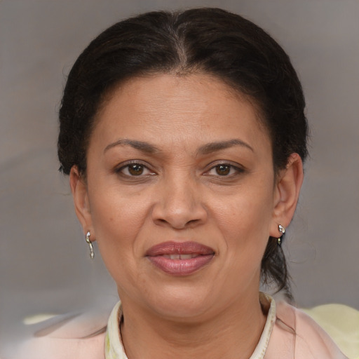 Joyful latino adult female with short  brown hair and brown eyes