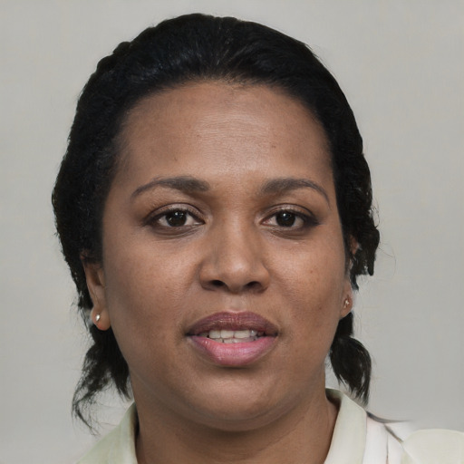 Joyful black young-adult female with medium  black hair and brown eyes