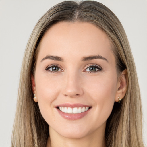 Joyful white young-adult female with long  brown hair and brown eyes