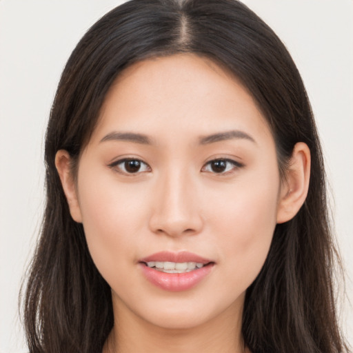 Joyful asian young-adult female with long  brown hair and brown eyes