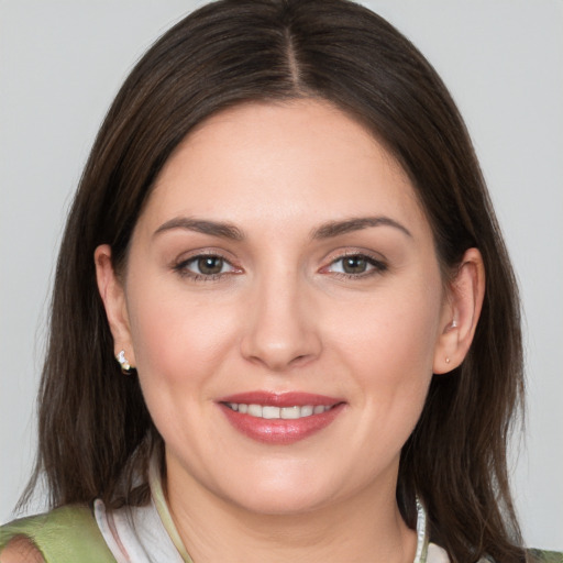 Joyful white young-adult female with medium  brown hair and brown eyes