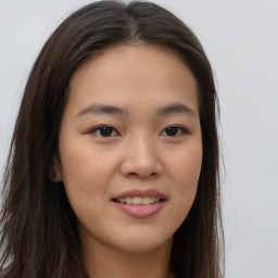 Joyful asian young-adult female with long  brown hair and brown eyes