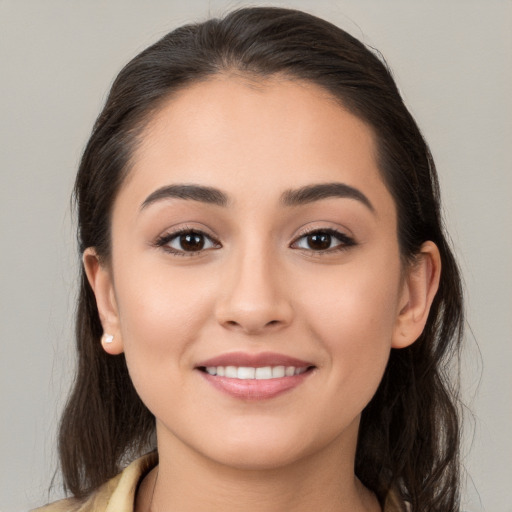 Joyful white young-adult female with long  brown hair and brown eyes