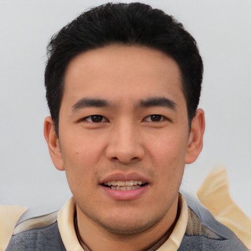 Joyful asian young-adult male with short  black hair and brown eyes