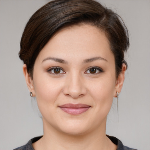 Joyful white young-adult female with medium  brown hair and brown eyes