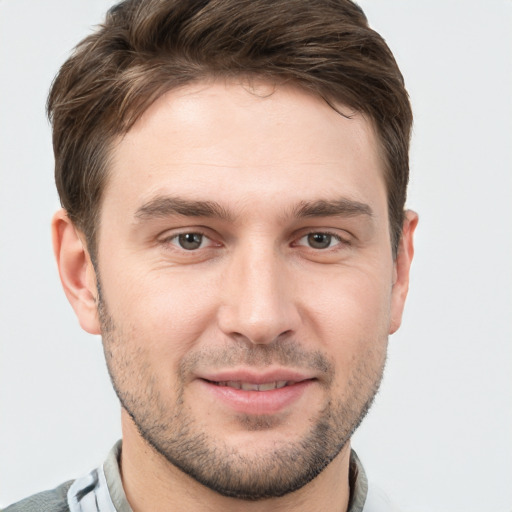 Joyful white young-adult male with short  brown hair and brown eyes