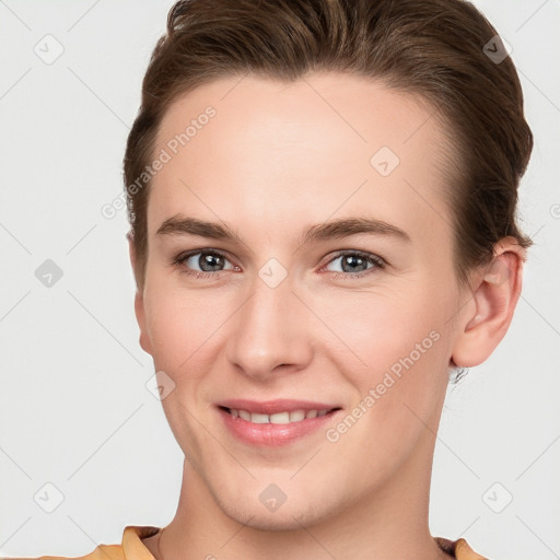 Joyful white young-adult female with short  brown hair and grey eyes