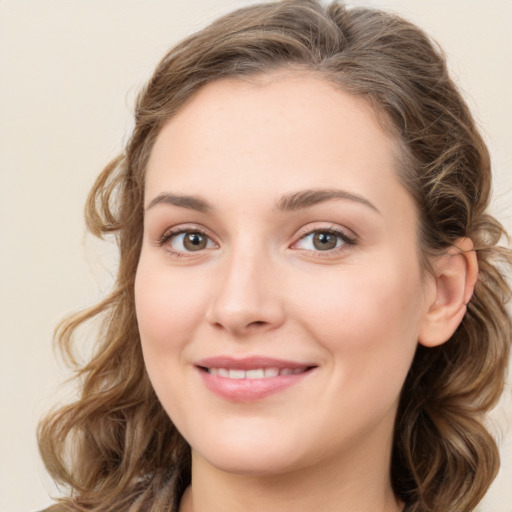 Joyful white young-adult female with medium  brown hair and green eyes