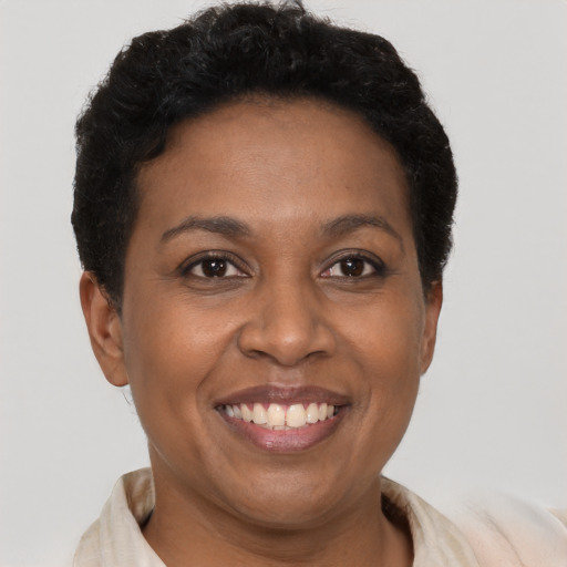 Joyful black adult female with short  brown hair and brown eyes