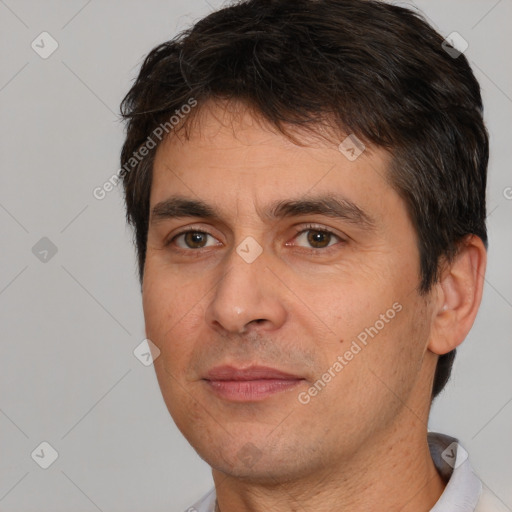 Joyful white adult male with short  brown hair and brown eyes