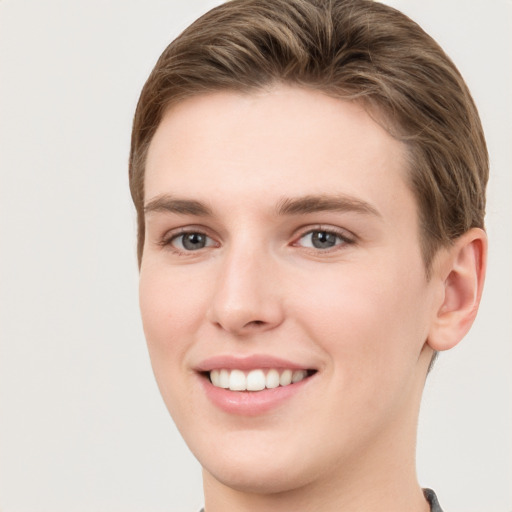 Joyful white young-adult female with short  brown hair and grey eyes