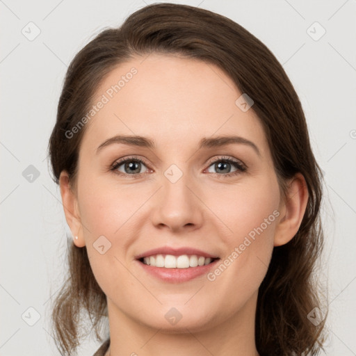 Joyful white young-adult female with medium  brown hair and grey eyes