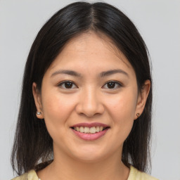 Joyful asian young-adult female with medium  brown hair and brown eyes