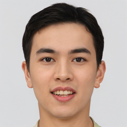 Joyful asian young-adult male with short  brown hair and brown eyes