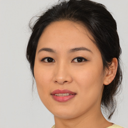Joyful asian young-adult female with medium  brown hair and brown eyes