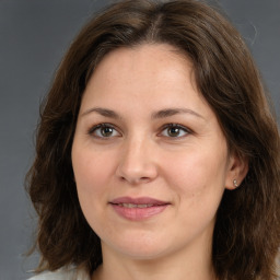 Joyful white adult female with medium  brown hair and brown eyes