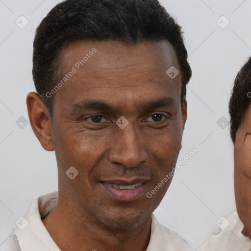 Joyful black adult male with short  brown hair and brown eyes