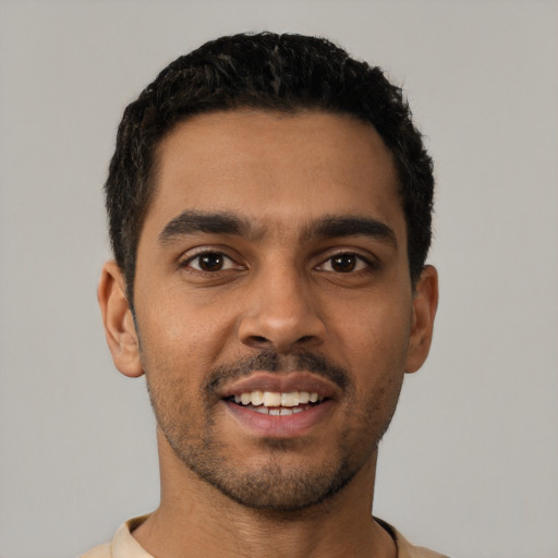 Joyful latino young-adult male with short  black hair and brown eyes
