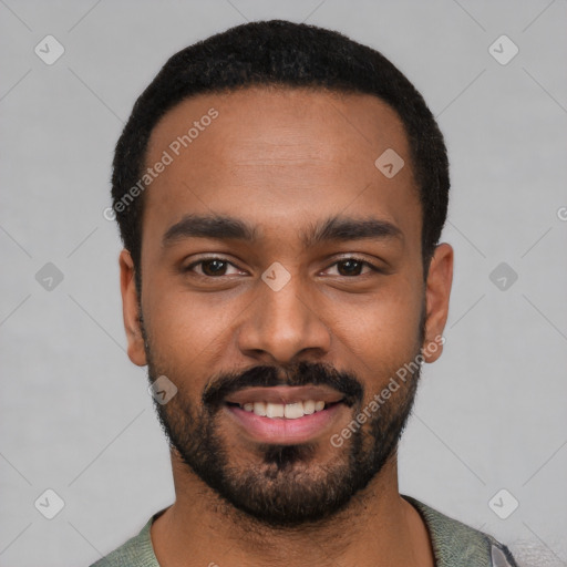 Joyful black young-adult male with short  black hair and brown eyes