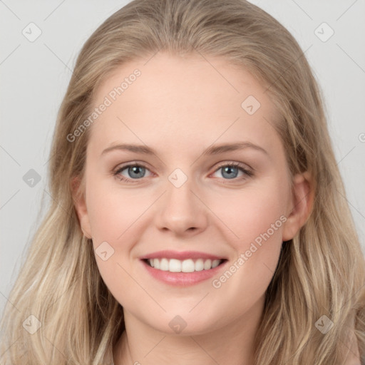 Joyful white young-adult female with long  brown hair and blue eyes