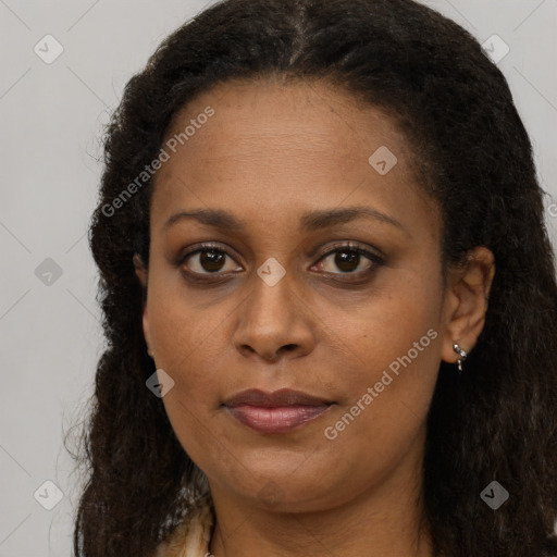 Joyful black adult female with long  brown hair and brown eyes
