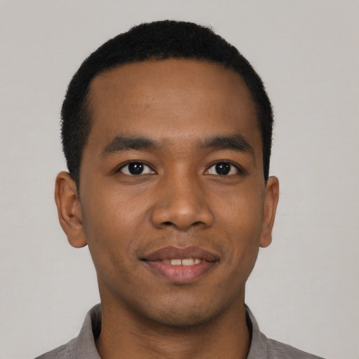 Joyful black young-adult male with short  black hair and brown eyes