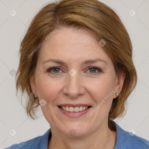 Joyful white adult female with medium  brown hair and blue eyes