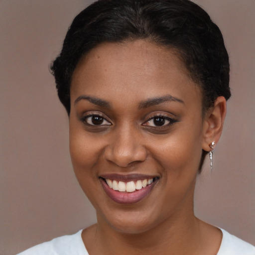 Joyful black young-adult female with short  brown hair and brown eyes