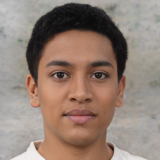 Joyful latino young-adult male with short  brown hair and brown eyes