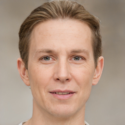 Joyful white adult male with short  brown hair and grey eyes