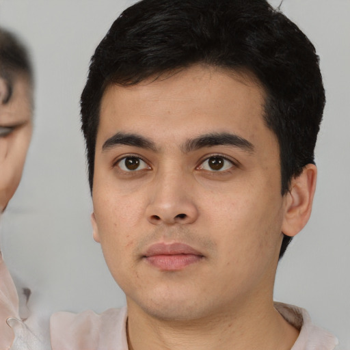 Neutral latino young-adult male with short  black hair and brown eyes