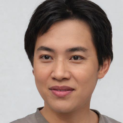 Joyful asian young-adult male with short  black hair and brown eyes