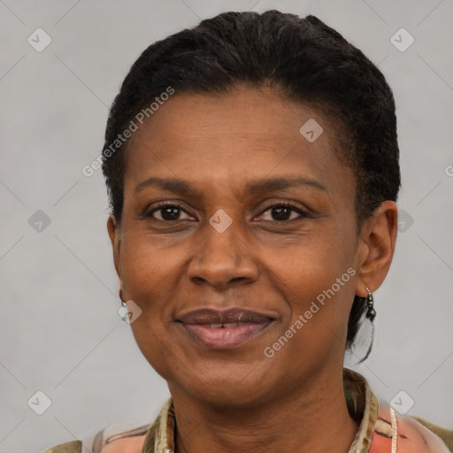 Joyful black adult female with short  brown hair and brown eyes