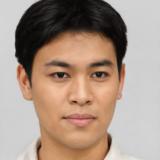 Joyful asian young-adult male with short  brown hair and brown eyes