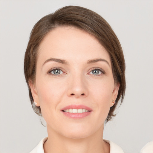 Joyful white young-adult female with medium  brown hair and grey eyes