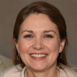 Joyful white adult female with medium  brown hair and brown eyes