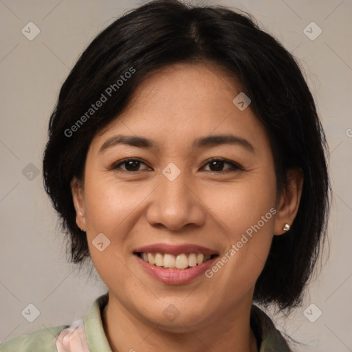 Joyful latino adult female with medium  brown hair and brown eyes