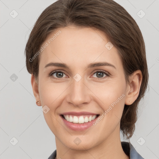 Joyful white young-adult female with medium  brown hair and grey eyes