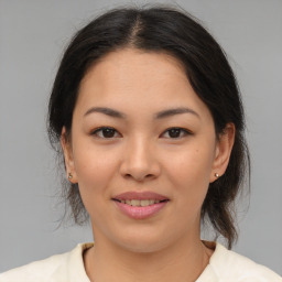 Joyful asian young-adult female with medium  brown hair and brown eyes