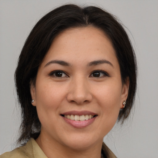 Joyful white young-adult female with medium  brown hair and brown eyes