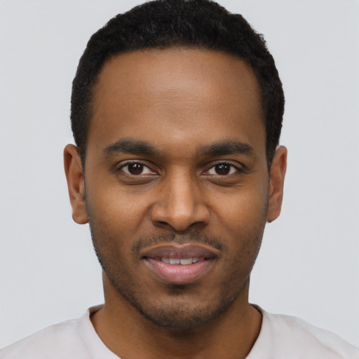 Joyful black young-adult male with short  black hair and brown eyes