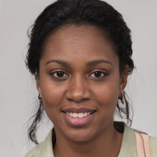 Joyful black young-adult female with medium  brown hair and brown eyes