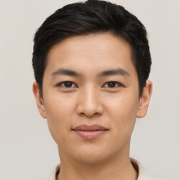 Joyful asian young-adult male with short  black hair and brown eyes