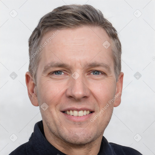 Joyful white adult male with short  brown hair and grey eyes