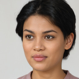 Joyful latino young-adult female with medium  brown hair and brown eyes