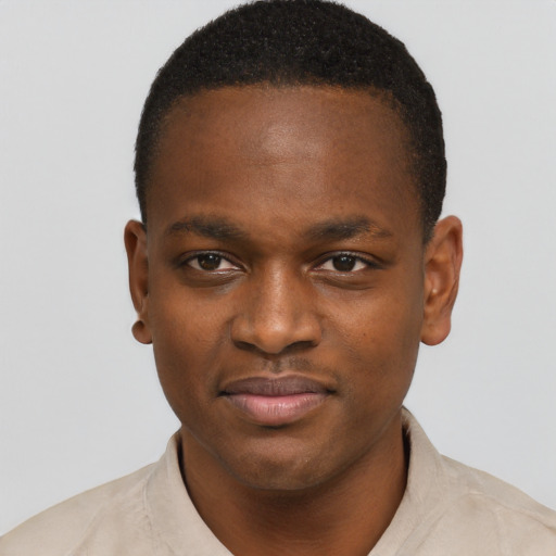 Joyful black young-adult male with short  brown hair and brown eyes