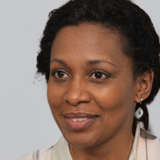 Joyful black adult female with short  brown hair and brown eyes