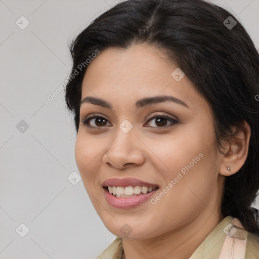 Joyful latino young-adult female with medium  brown hair and brown eyes