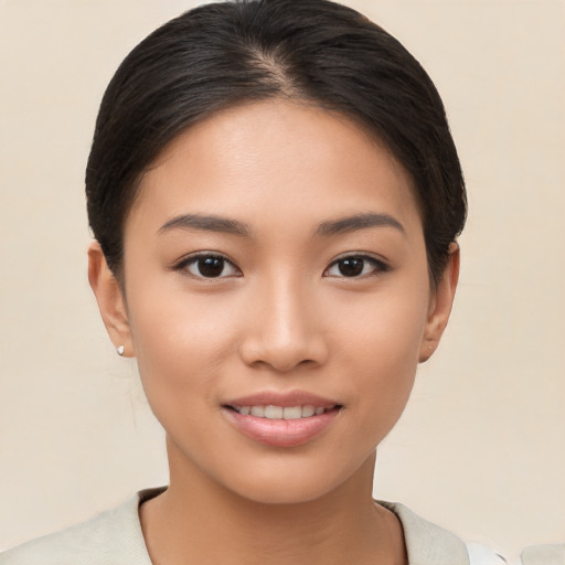 Joyful asian young-adult female with short  brown hair and brown eyes